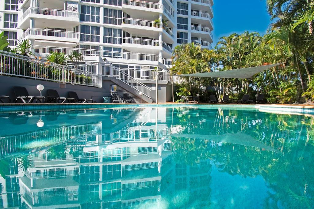 a swimming pool in front of a building at Ocean Sands Resort in Gold Coast