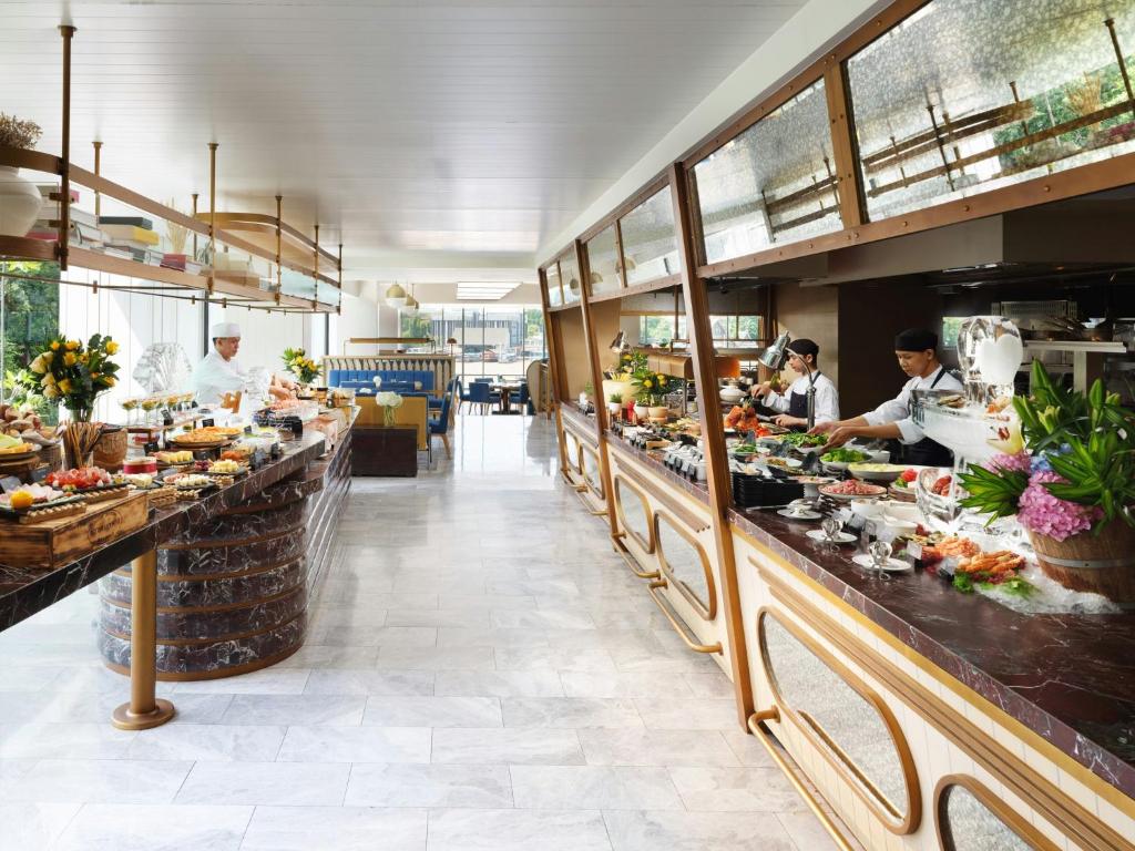 A bright buffet restaurant with staffed food counters on both sides.