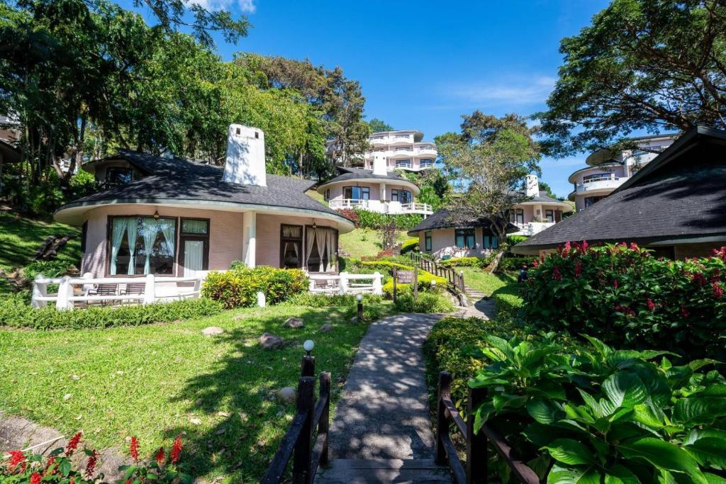 a small house in a yard with a pathway at Imperial Phukaew Hill Resort in Khao Kho