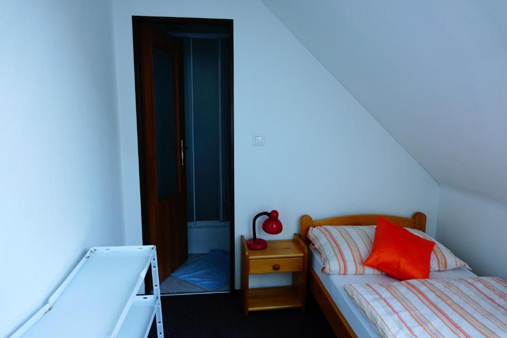 A bed or beds in a room at Penzion U Studánky