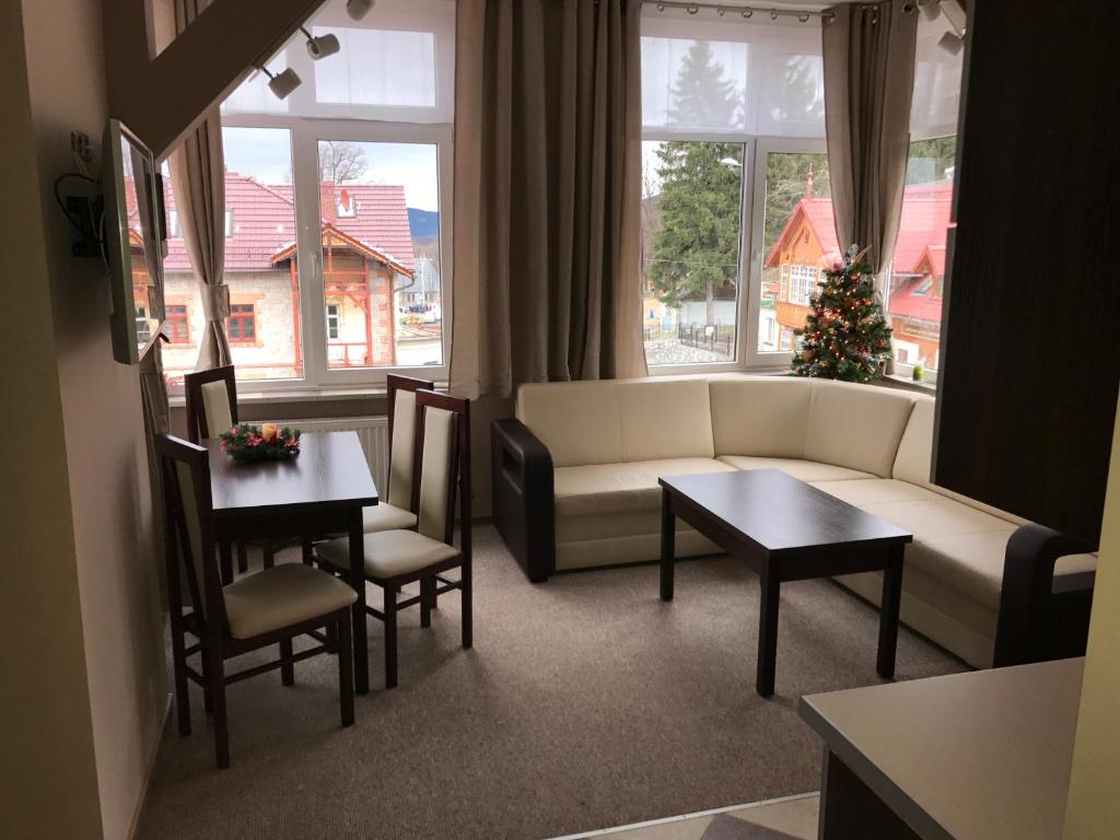 a living room with a couch and a table at Apartamenty Kostka in Karpacz