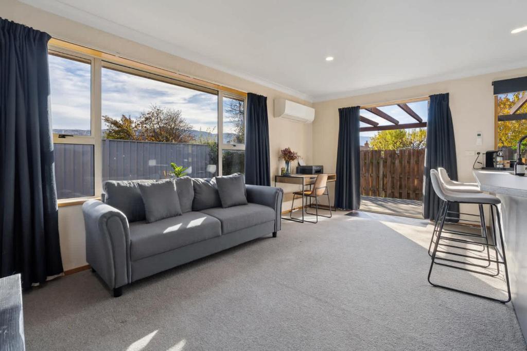 a living room with a couch and a table at Haven on Molyneux in Cromwell