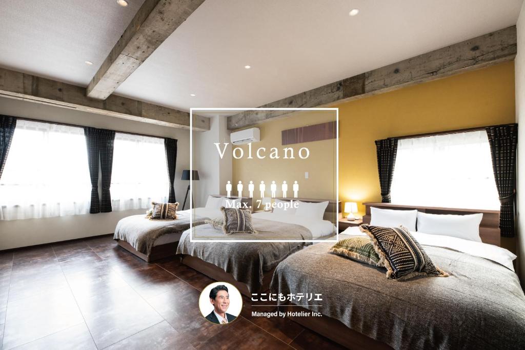 a hotel room with two beds and a mirror at Volcano in Kagoshima