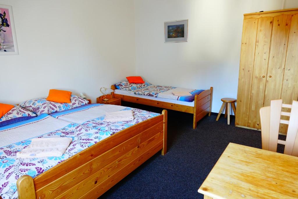 A bed or beds in a room at Penzion U Studánky