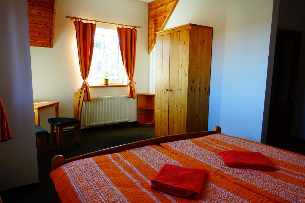 A bed or beds in a room at Penzion U Studánky