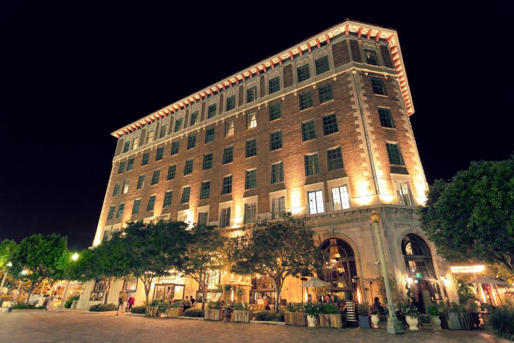 a large building with lights on it at night at The Culver Hotel in Los Angeles
