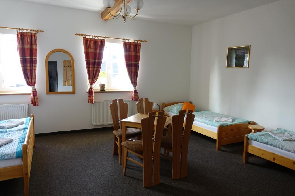 A bed or beds in a room at Penzion U Studánky