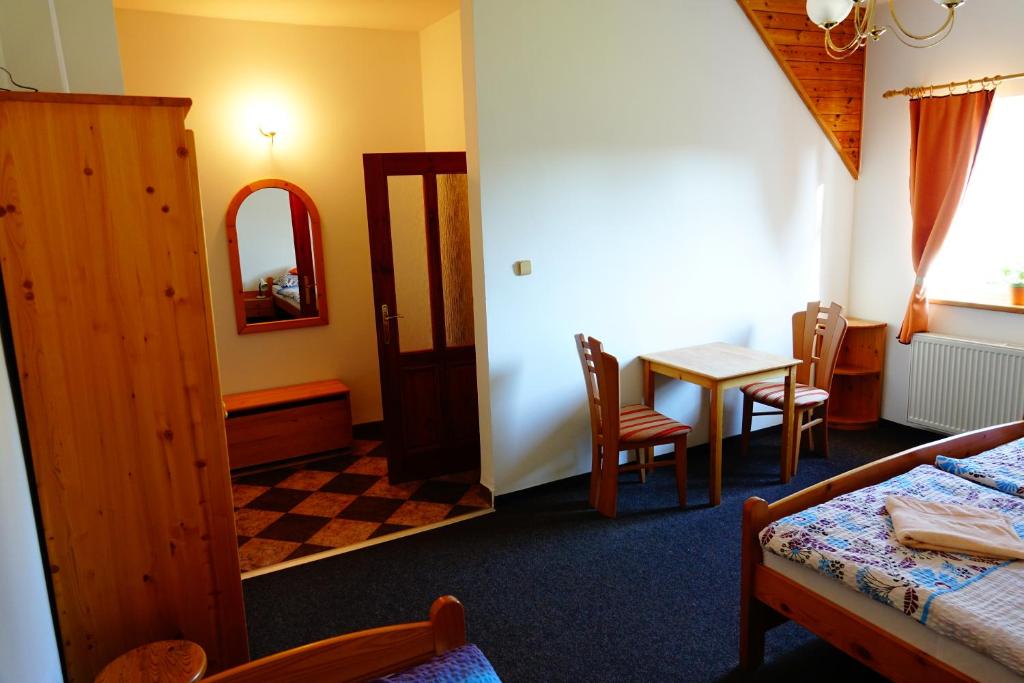A bed or beds in a room at Penzion U Studánky
