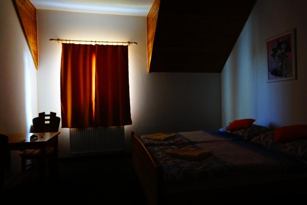 A bed or beds in a room at Penzion U Studánky