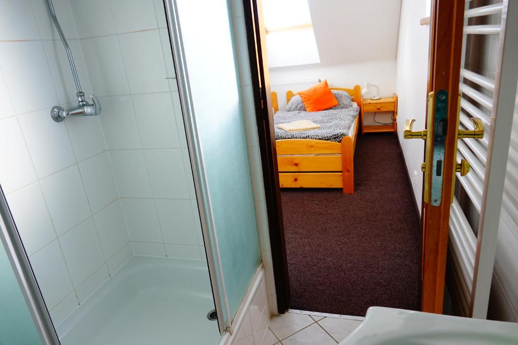 A bed or beds in a room at Penzion U Studánky