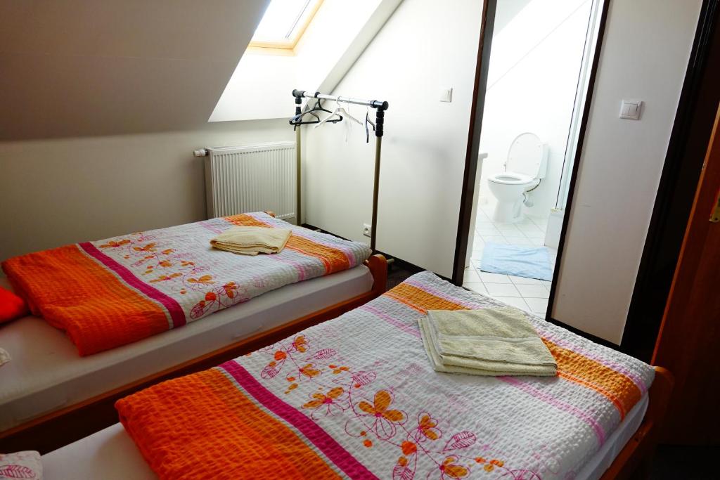 A bed or beds in a room at Penzion U Studánky