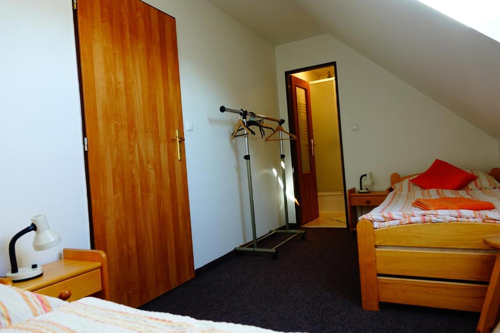 A bed or beds in a room at Penzion U Studánky