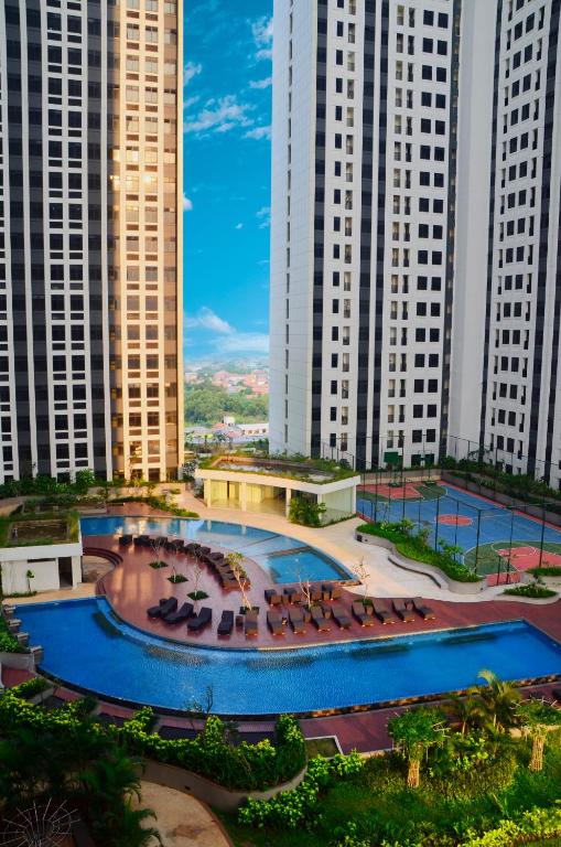 a large pool in front of tall buildings at Louis Kienne Reserve Cikarang in Cikarang