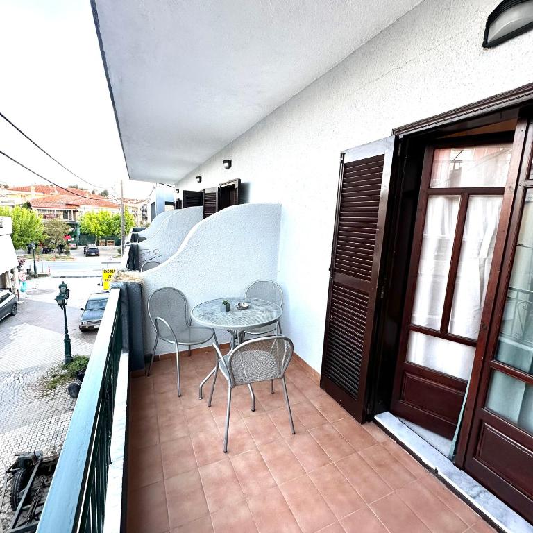 a patio with a table and chairs on a balcony at Liberty Studio in Kallithea Halkidikis