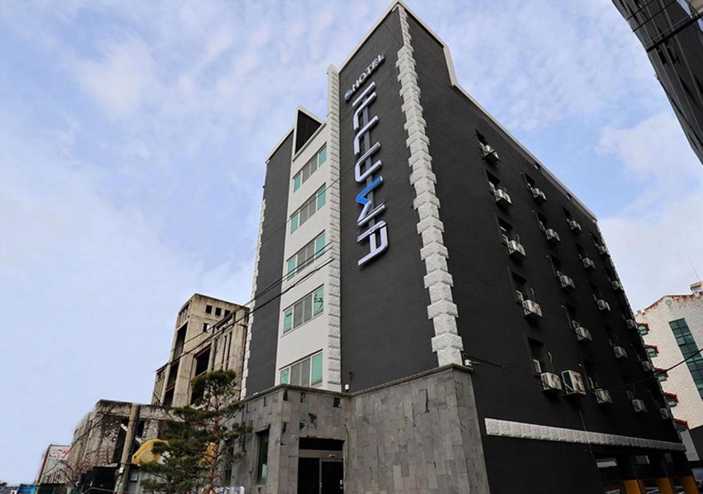 a building with a sign on the side of it at Incheon Illuwa Hotel in Incheon