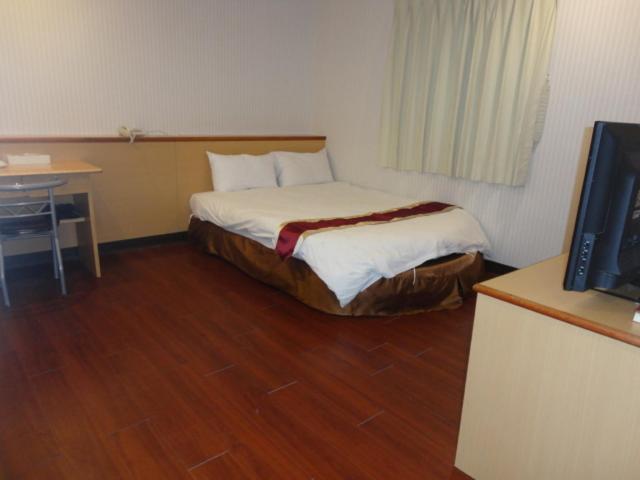 Postel nebo postele na pokoji v ubytování Yi Pin Yuan Hotel