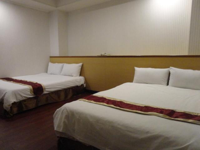 Postel nebo postele na pokoji v ubytování Yi Pin Yuan Hotel