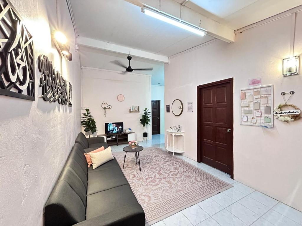 a living room with a couch and a table at Homestay Teera in Chemor