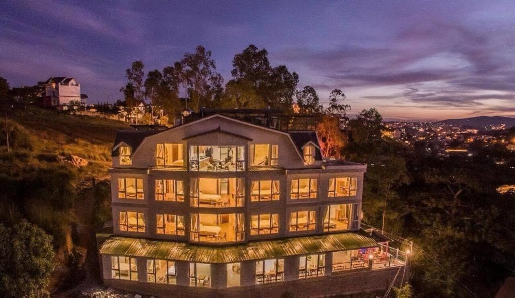 a large building on top of a hill at night at Starview Villa Dalat in Da Lat