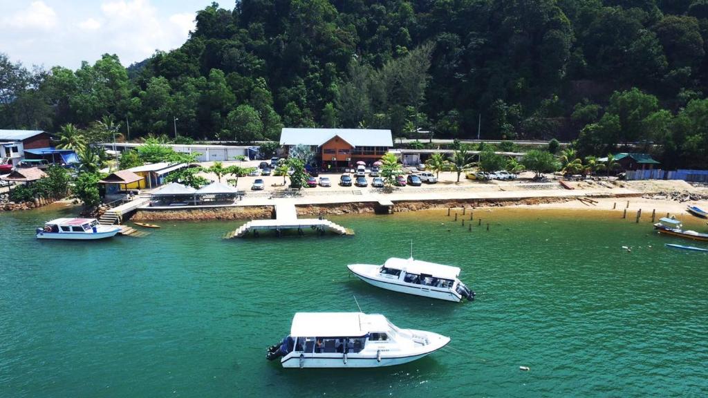 a group of boats in a body of water at Riverbank Dungun Guesthouse & Cafe in Dungun