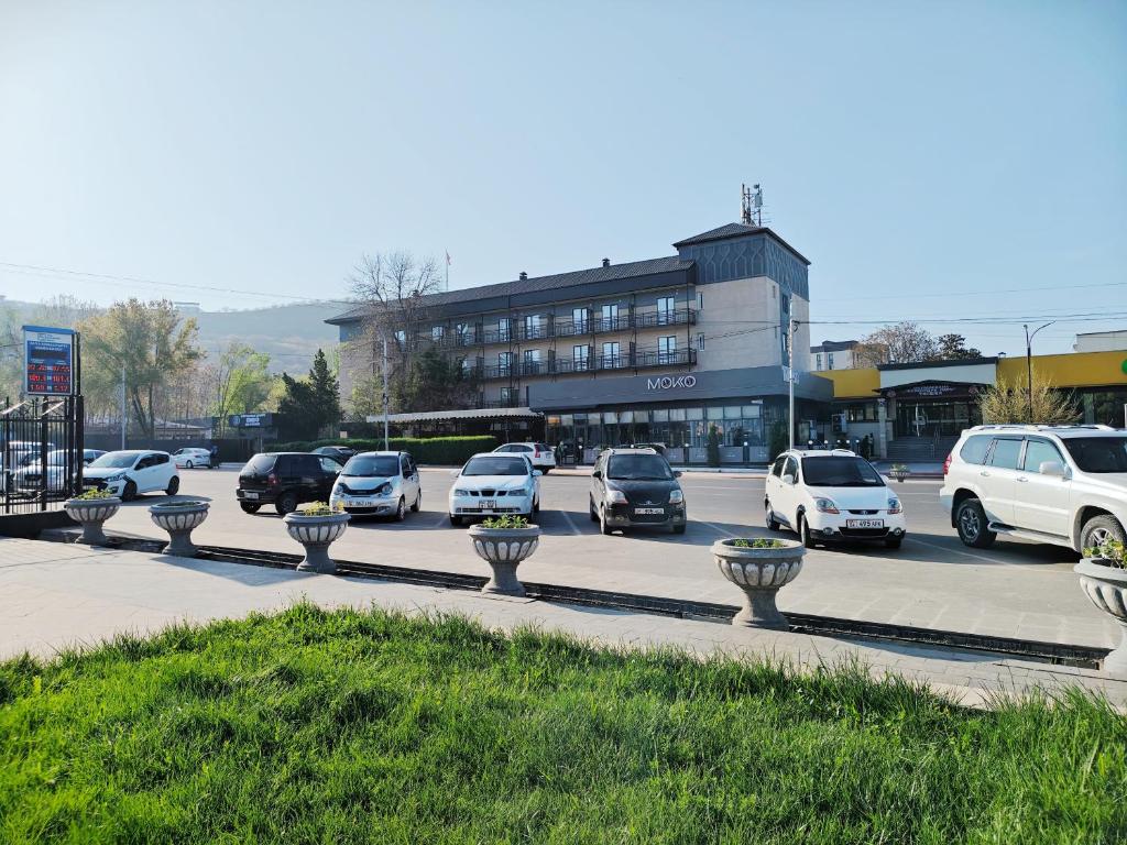 a group of cars parked in a parking lot at Central Park Hotel 中央公园酒店 in Jalal-Abad