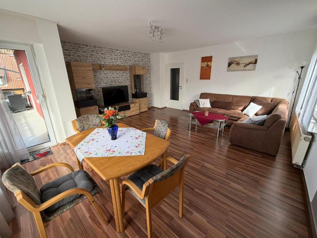 a living room with a table and a couch at Ferienwohnung Alina in Hilders