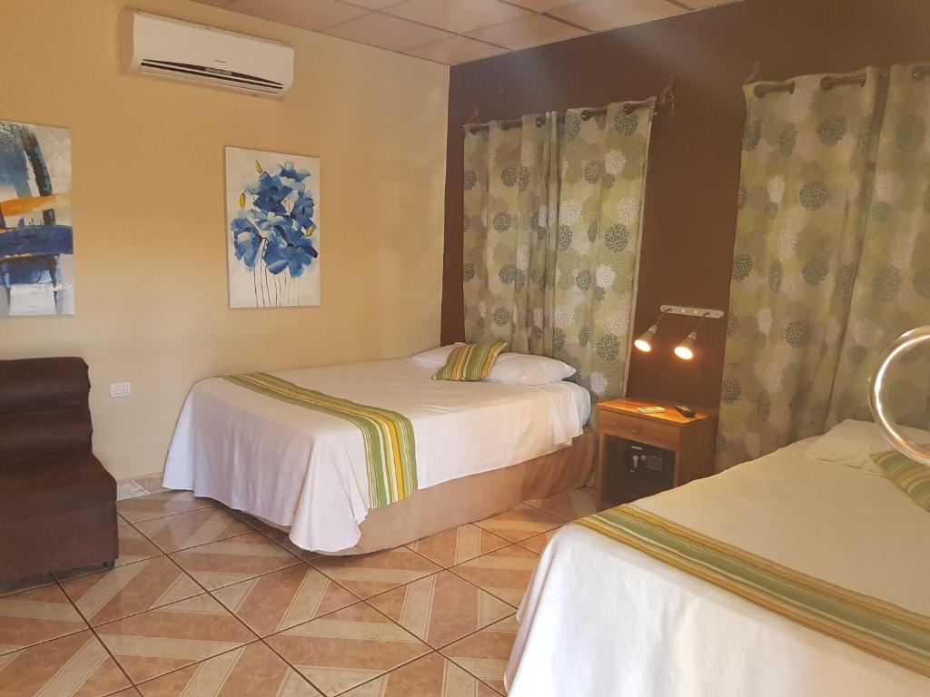 una habitación de hotel con 2 camas en una habitación en Hotel Miraflores, en El Cuco