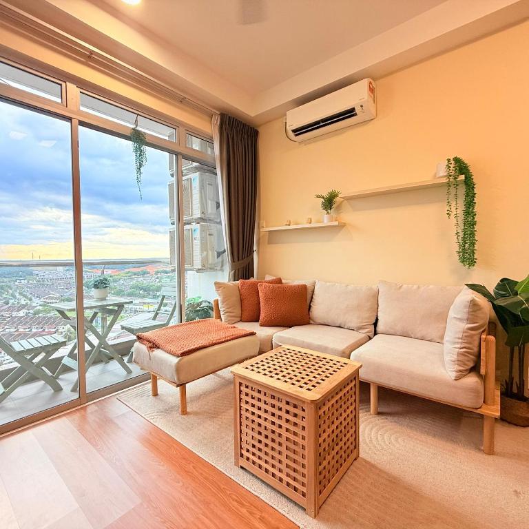 a living room with a couch and a large window at KULAI IOI MALL D'Putra Suites Near JPO Senai Airport in Kampong Saleng