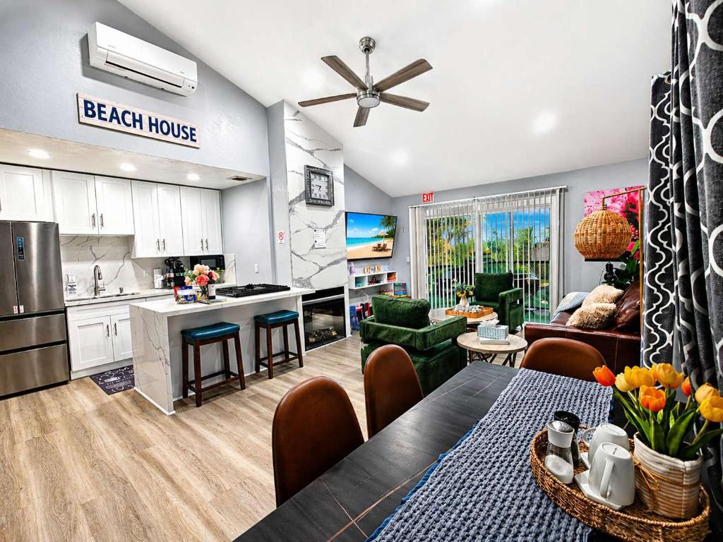 a kitchen and a living room with a table and a dining room at Endless Sunset- Near Beach Surf and Pet Friendly in Huntington Beach
