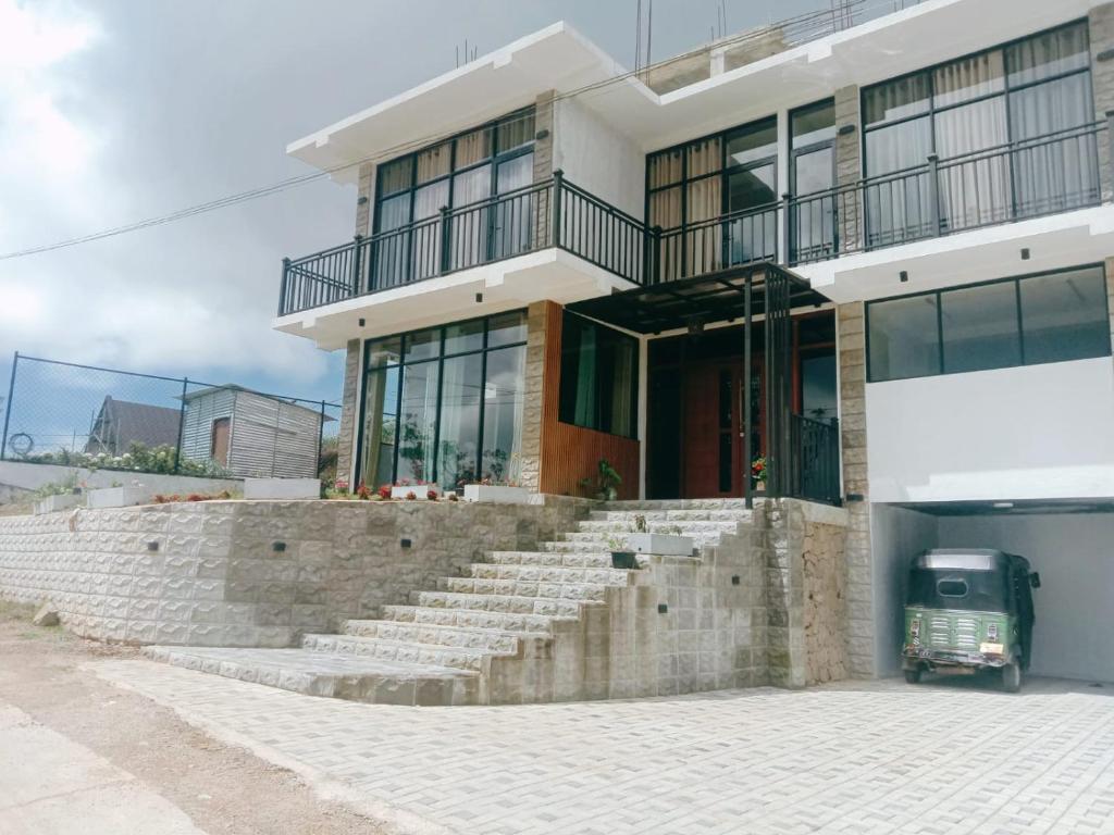 a building with stairs in front of a building at Falcon View in Nuwara Eliya