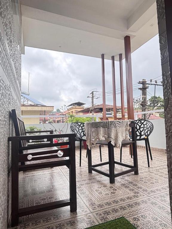 a table and chairs on a patio with a view at R's Bolli Kudike in Madikeri