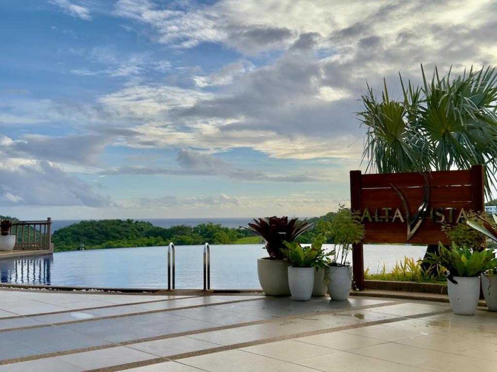 a bench on a patio with a view of the water at Alta Vista Residences H102 in Boracay
