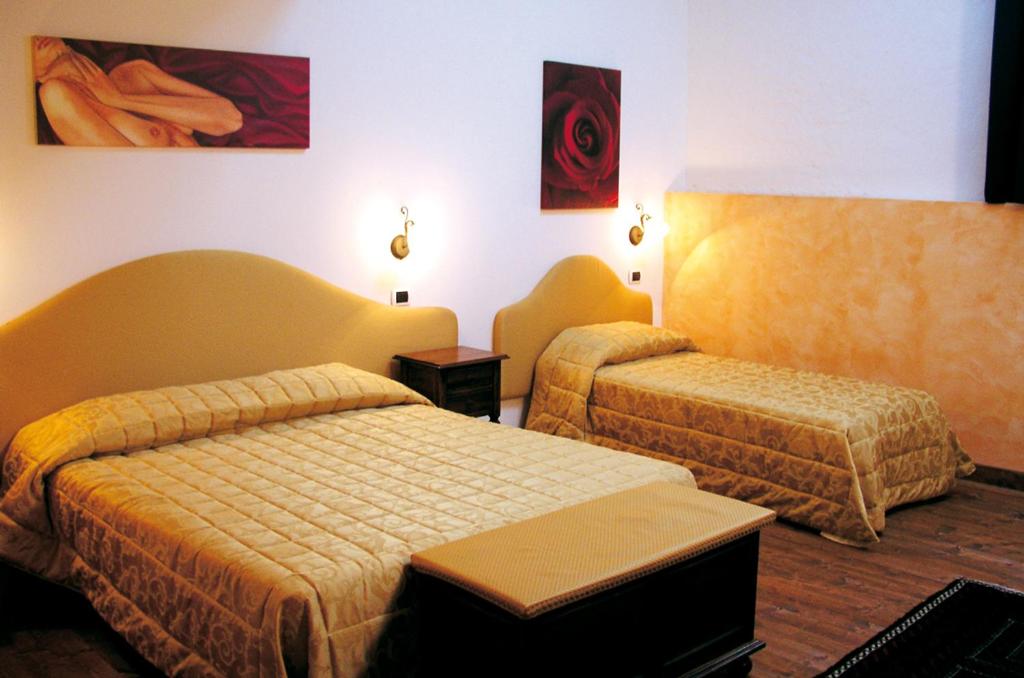 Postel nebo postele na pokoji v ubytování Hotel Al Barco