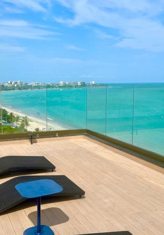a room with a view of the ocean and two yoga mats at Edifício New Time Apto 1016 Pajuçara Maceió AL in Maceió