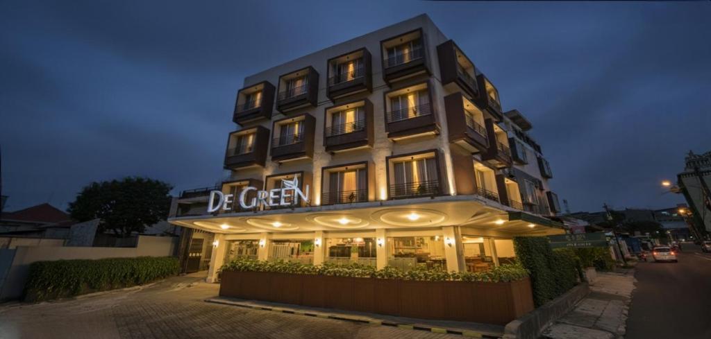 a building with a sign on the front of it at Hotel De Green Lampung in Lampung