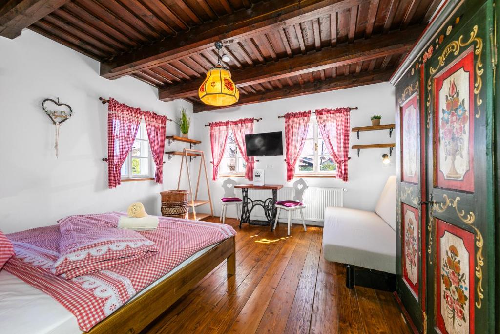 a bedroom with a bed and a desk in a room at Penzion Sněžná Volary in Volary