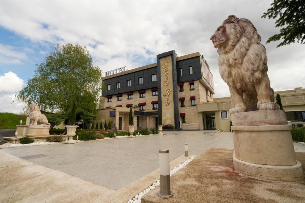 a statue of a lion in front of a building at Hotel Santa Ria in Kŭrdzhali