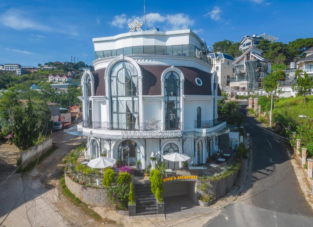 a large building with a turret at Dalat Hotel & Villa by Pham Gia in Xuan An