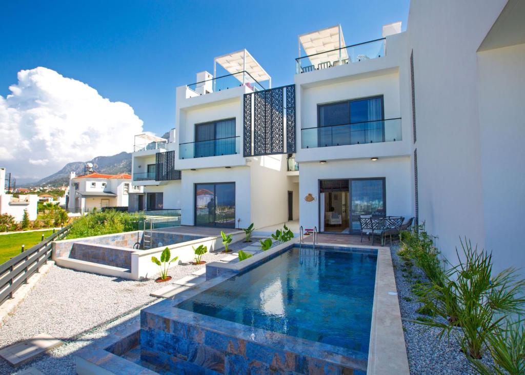 a house with a swimming pool in front of it at Aqualina E4-1 by HolidayKeys in Kyrenia