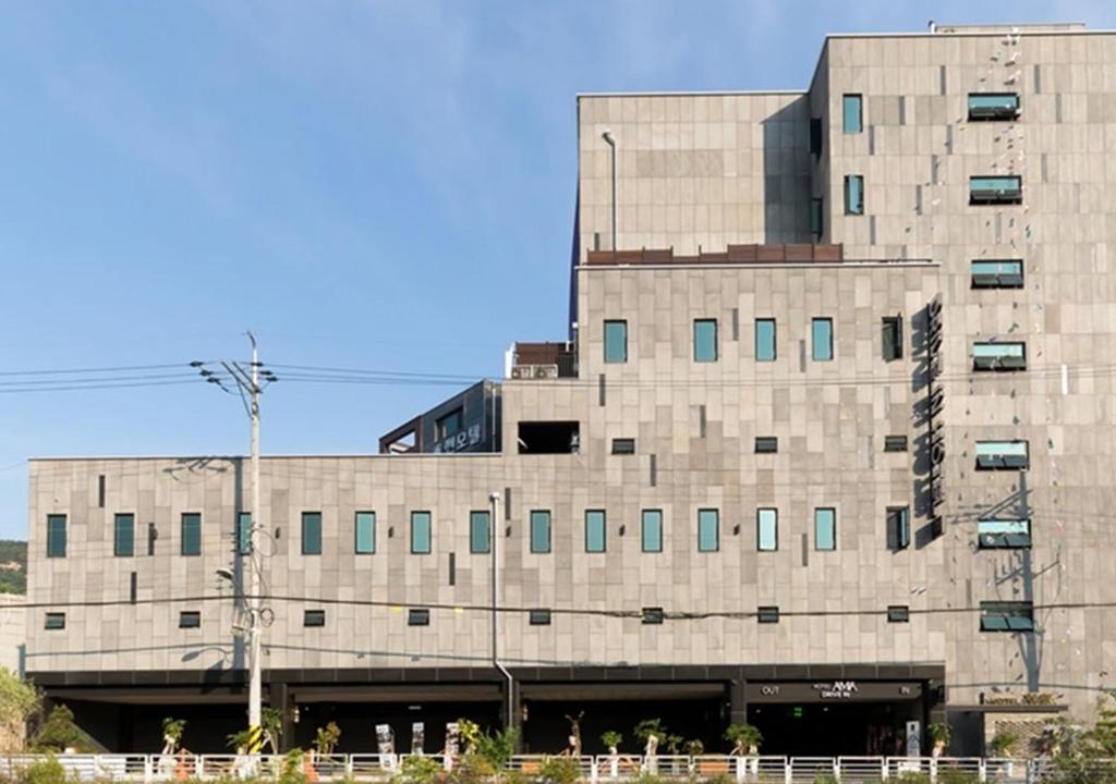 a large concrete building with a lot of windows at Anyang Boutique Hotel AMA in Anyang