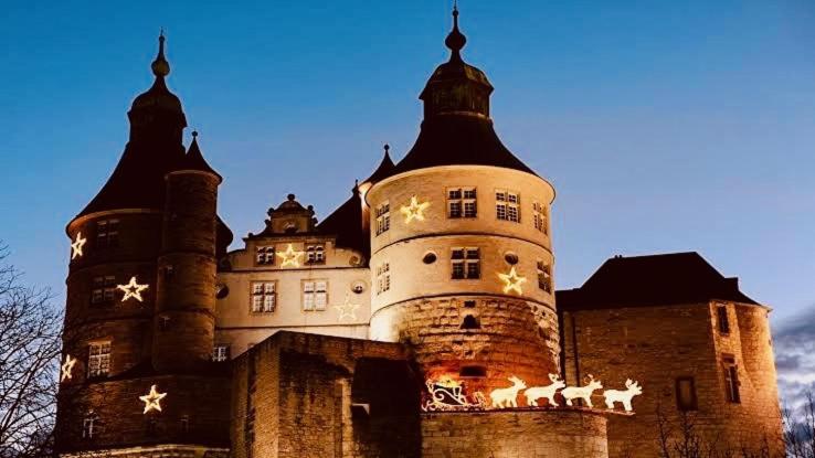 a castle with christmas decorations on the side of it at Loft Sous Pref in Montbéliard