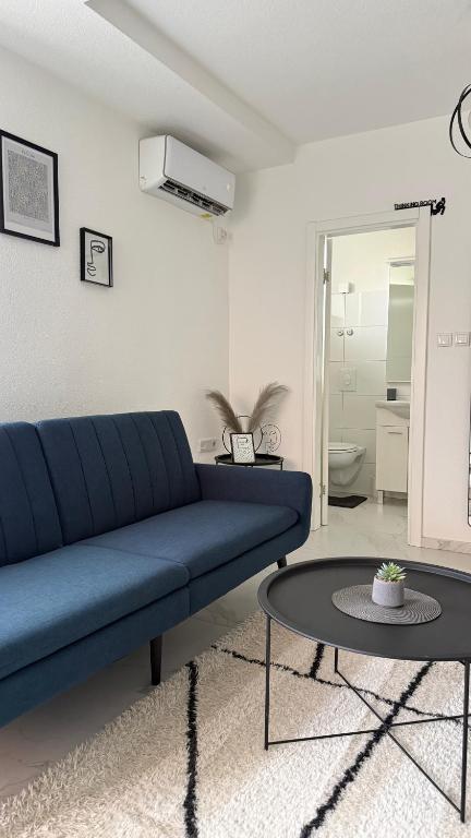 a living room with a blue couch and a table at Lena 2 in Jajce