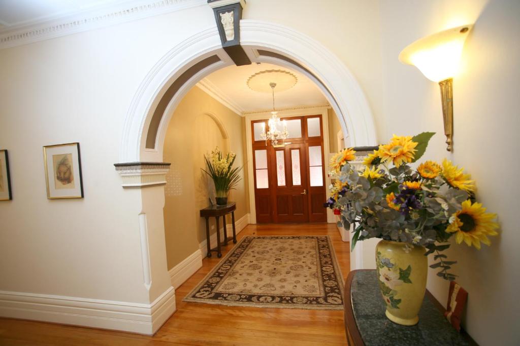 a hallway with a vase with flowers in it at Darcy's Hotel in Sydney