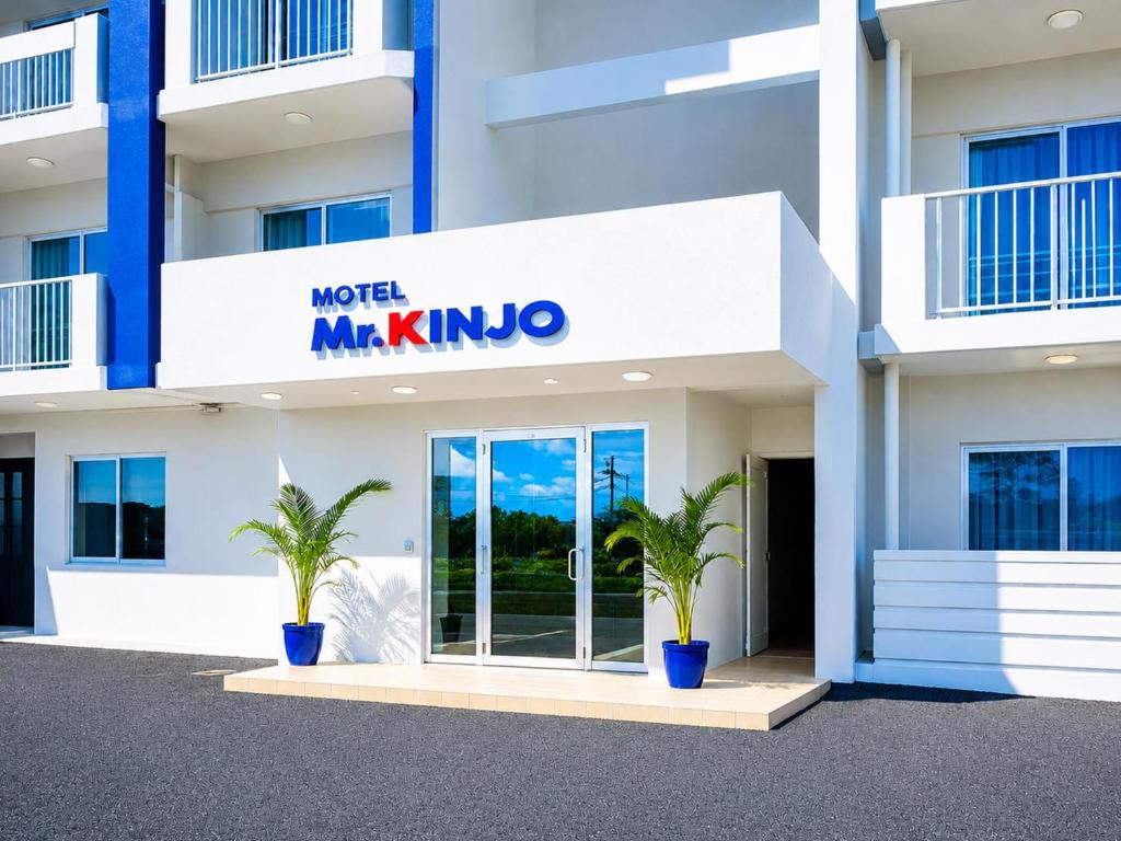 a building with two palm trees in front of it at MrKINJO in Air Resort in Hirara