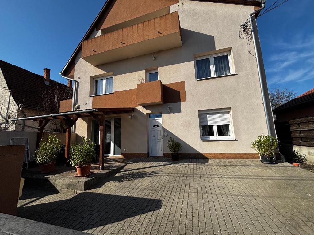 a house with a brick driveway in front of it at Maxi Apartman in Budaörs