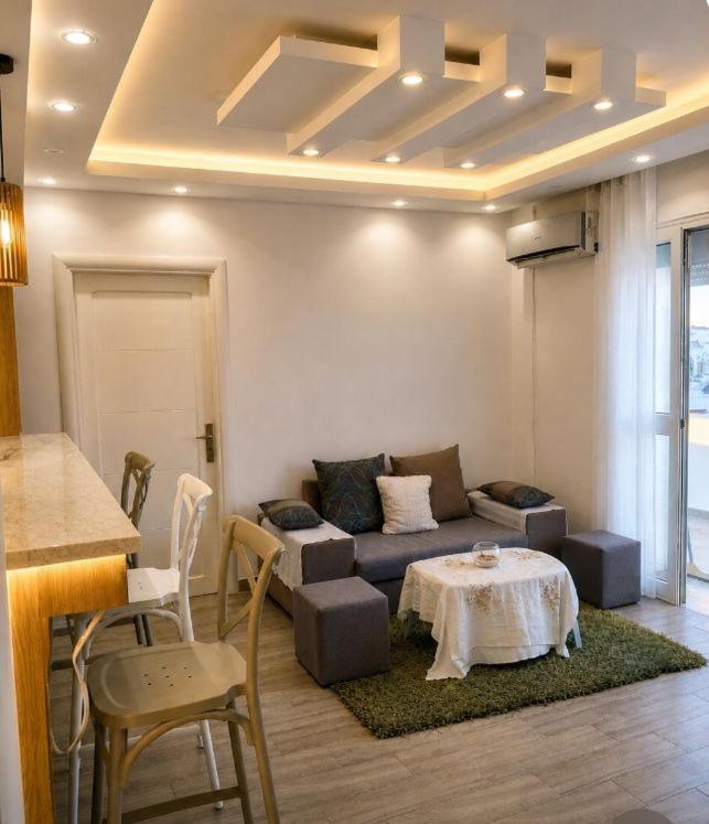 a living room with a couch and a table at Résidence Nour in Monastir