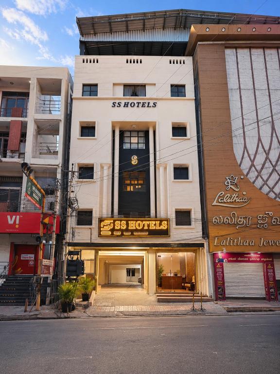 a white building with a sign on the front of it at Open Hotel by Olive - G SILVER SS hotel in Tiruppūr