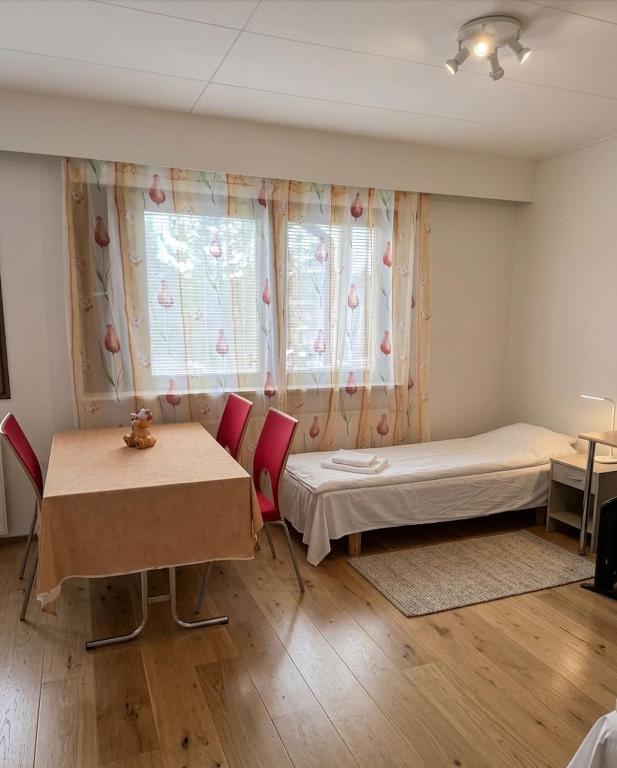 a room with a bed and a table and a window at DecaVillage Studios in Kuivanto