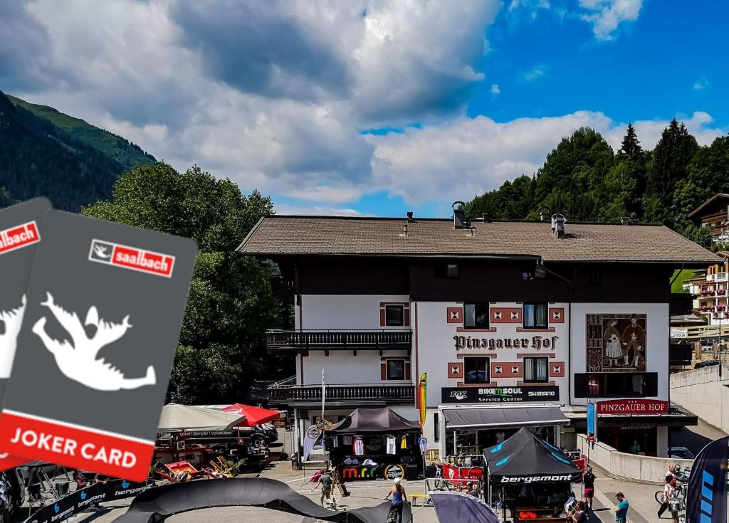 a large building in the middle of a town at Hotel Pinzgauerhof - Inclusive Evening Dinner in Saalbach-Hinterglemm