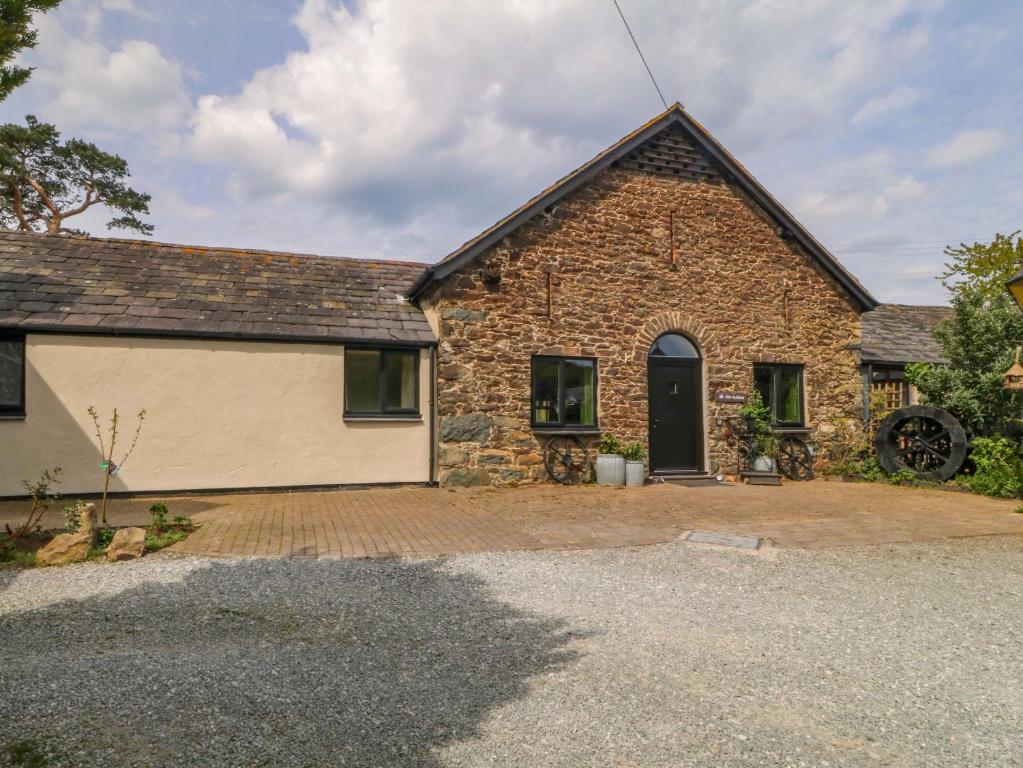 an old stone house with a garage at Pen Glorian in Conwy